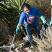 Sailor picks up trash during Operation Clean Sweep