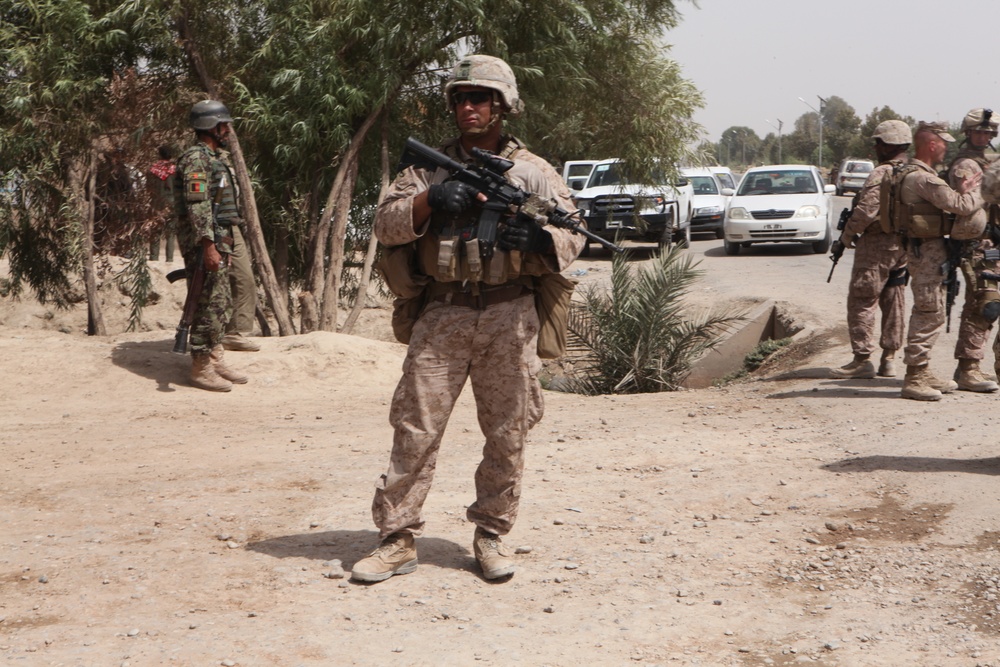 Marine provices security in Marjah during ceremony