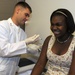 Sailor gives student immunization shot