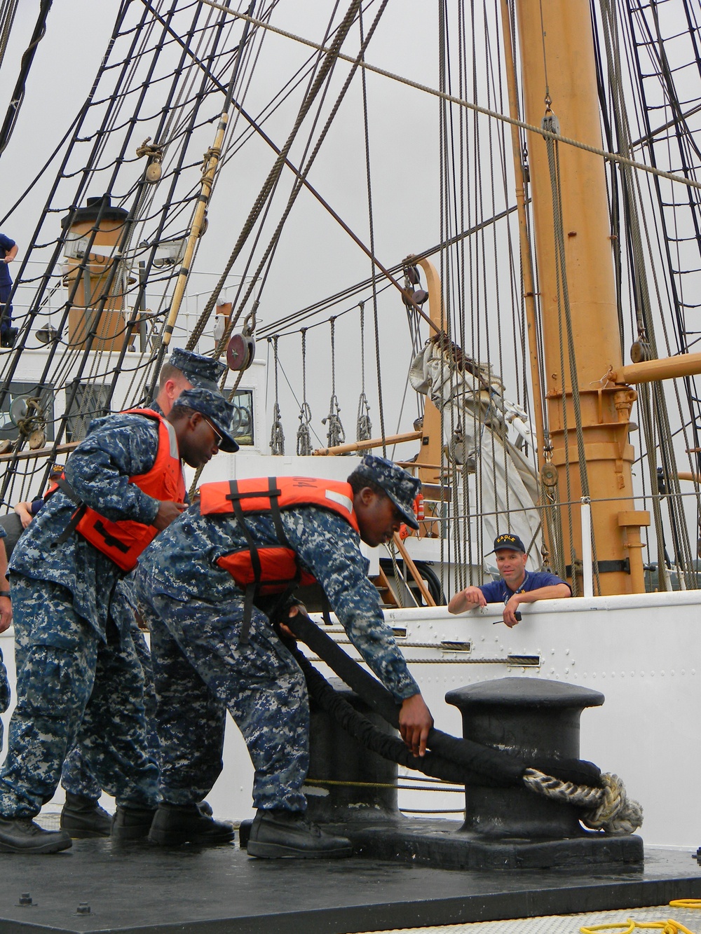 Sailors moor Barque Eagle before Hurricane Irene