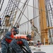 Sailors moor Barque Eagle before Hurricane Irene