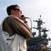 USS George H.W. Bush sailor guides landing