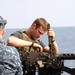 USS Dwight D. Eisenhower sailor checks machine gun