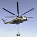 Helicopters lift fuel bladders off USS Makin Island