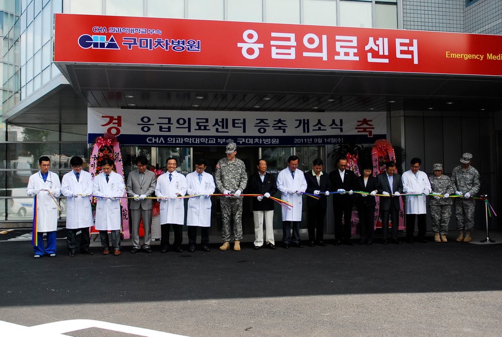 Doctors and staff along with Daegu US Army leaders cut a ribbon to celebrate the opening of the new wing at the Gumi Cha Hospital