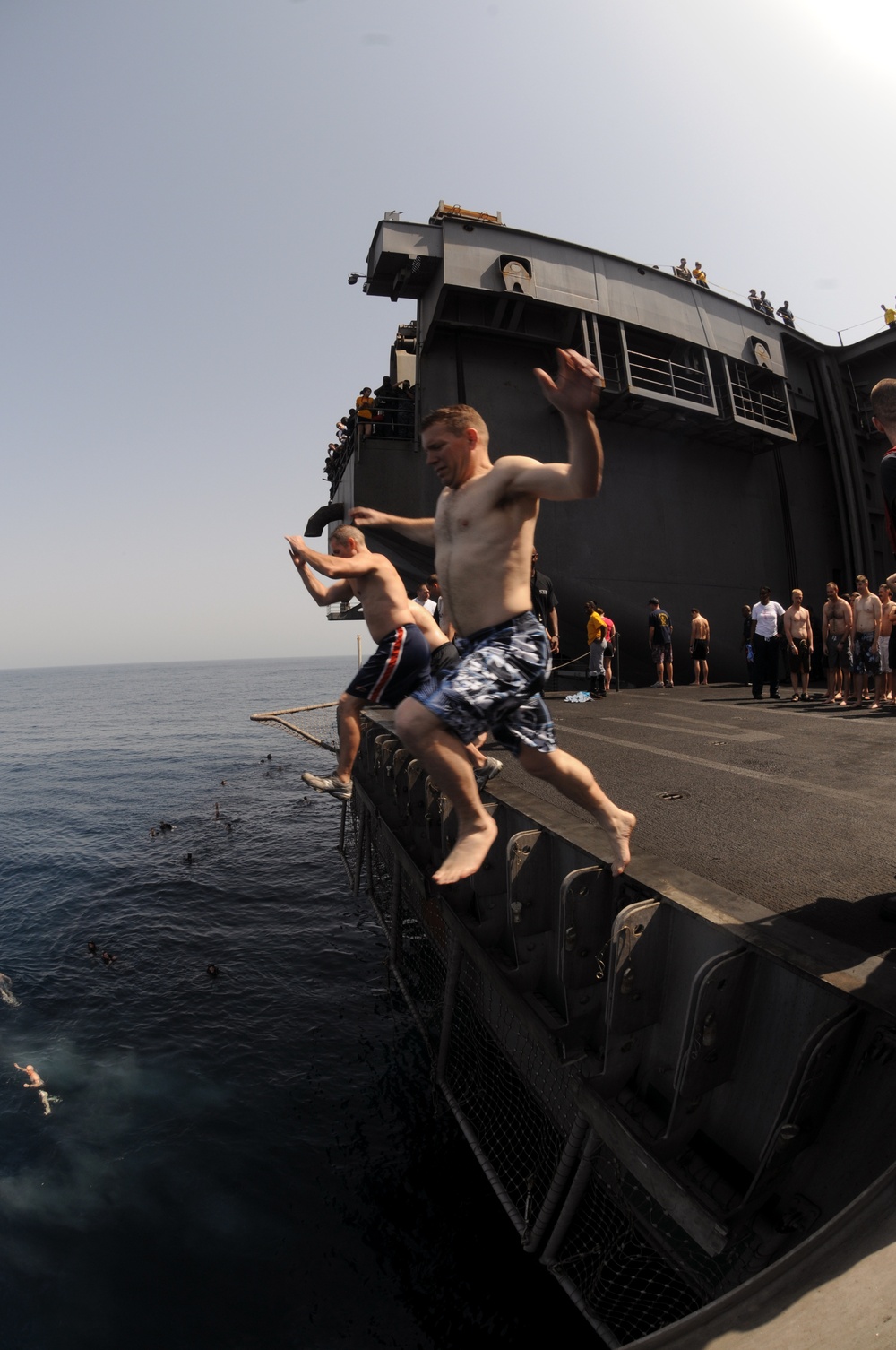 Sailor jumps into the water during USS George H.W. Bush swim call