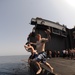 Sailor jumps into the water during USS George H.W. Bush swim call