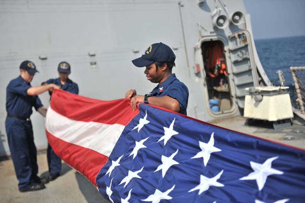 USS Truxtun sailors fold flag