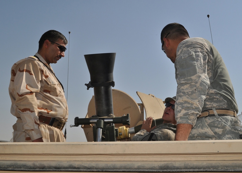 Iraqi commander learns how to handle a mortar.