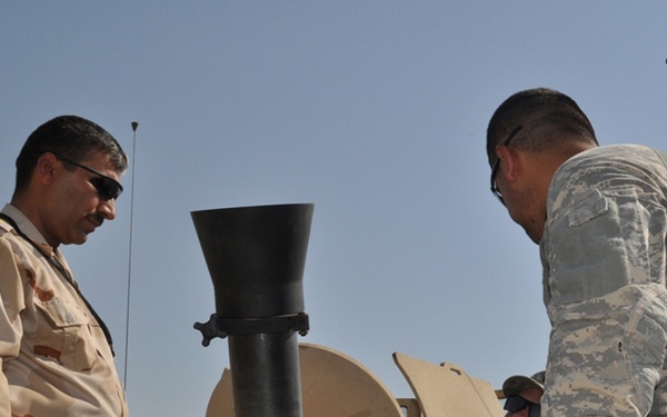 Iraqi commander learns how to handle a mortar.