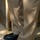 New SACEUR makes first visit to Kosovo The image shows the lower legs of a person wearing khaki/tan trousers and black dress shoes. One foot (right) is bare of covering and stands on a hard floor threshold, while the other foot (left) has a blue disposable shoe cover (bootie) over the shoe and stands on carpeted flooring. This suggests the person is in the process of either putting on or removing a protective shoe cover at a doorway transition.