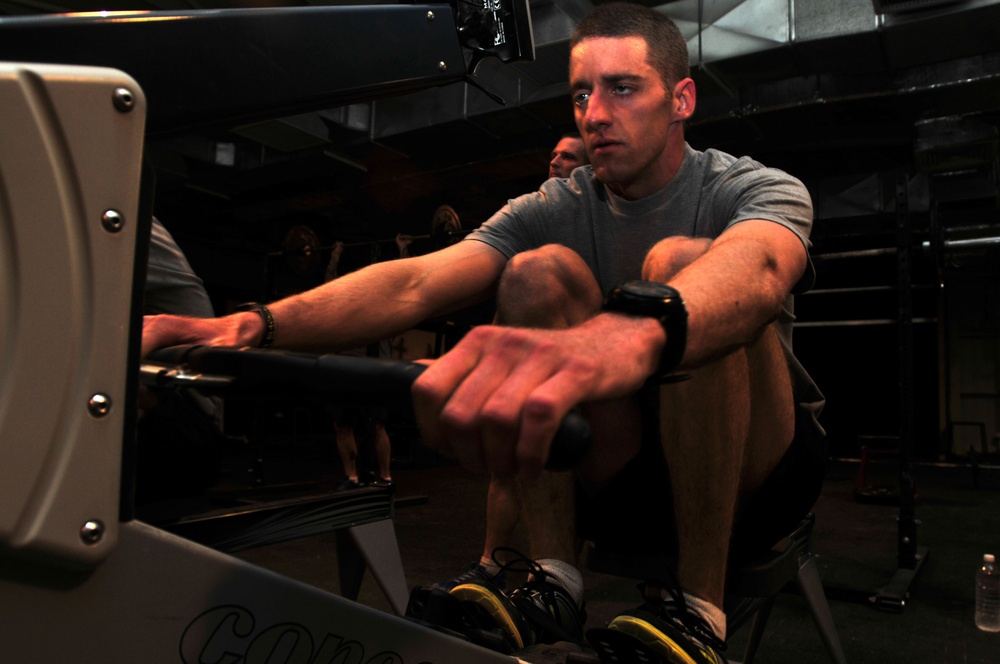 Soldier demonstrates rowing during a workout