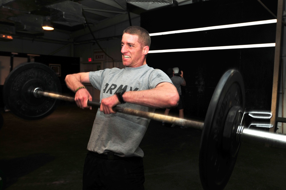 Soldier lifts weights during workout routine