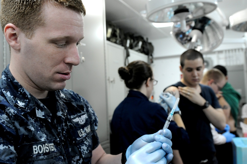 USS George H.W. Bush sailor administers flu shot