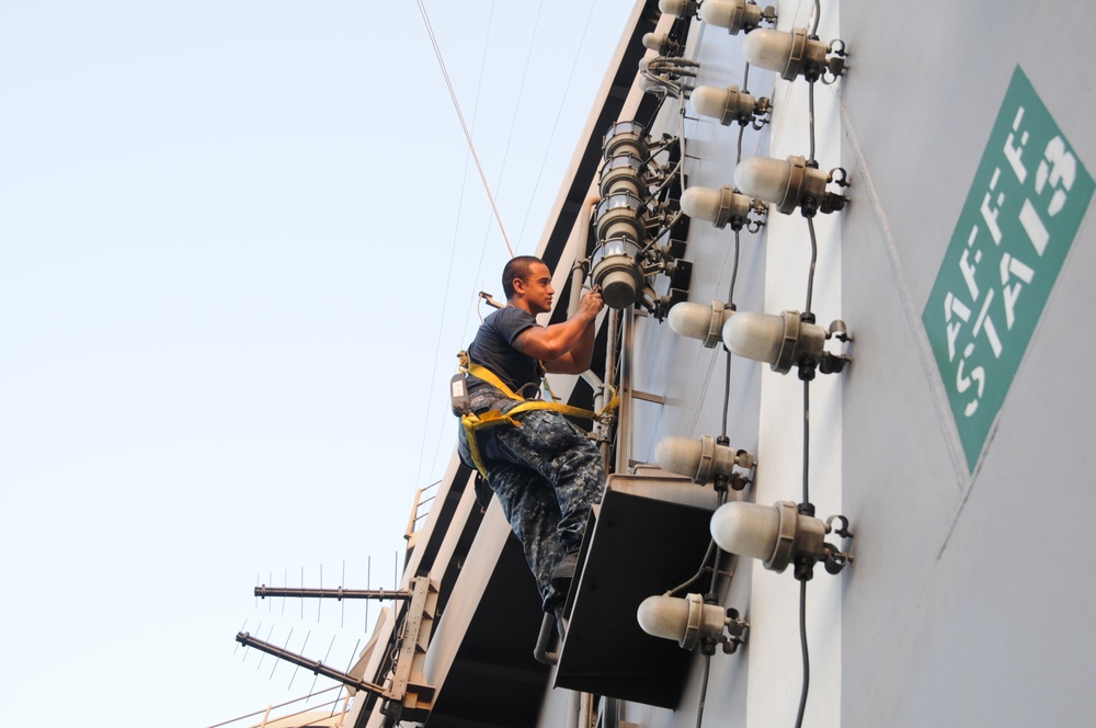 USS George H.W. Bush sailor does maintenance on rotary beacon