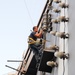 USS George H.W. Bush sailor does maintenance on rotary beacon