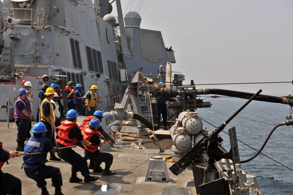 USS Truxtun sailors heave a line