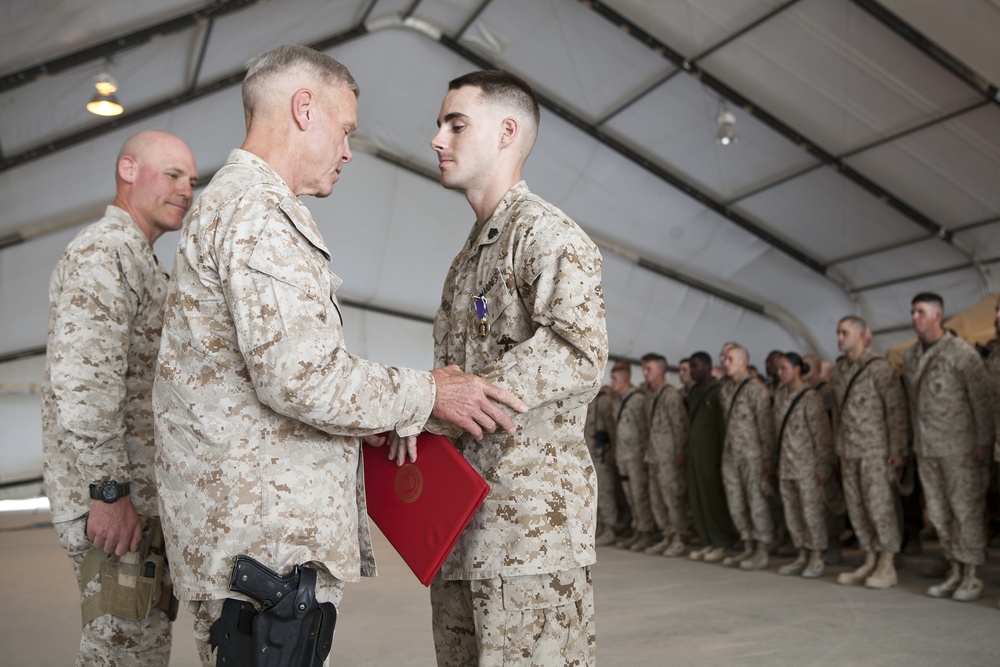 Top Marine general pins Purple Heart on helicopter technician