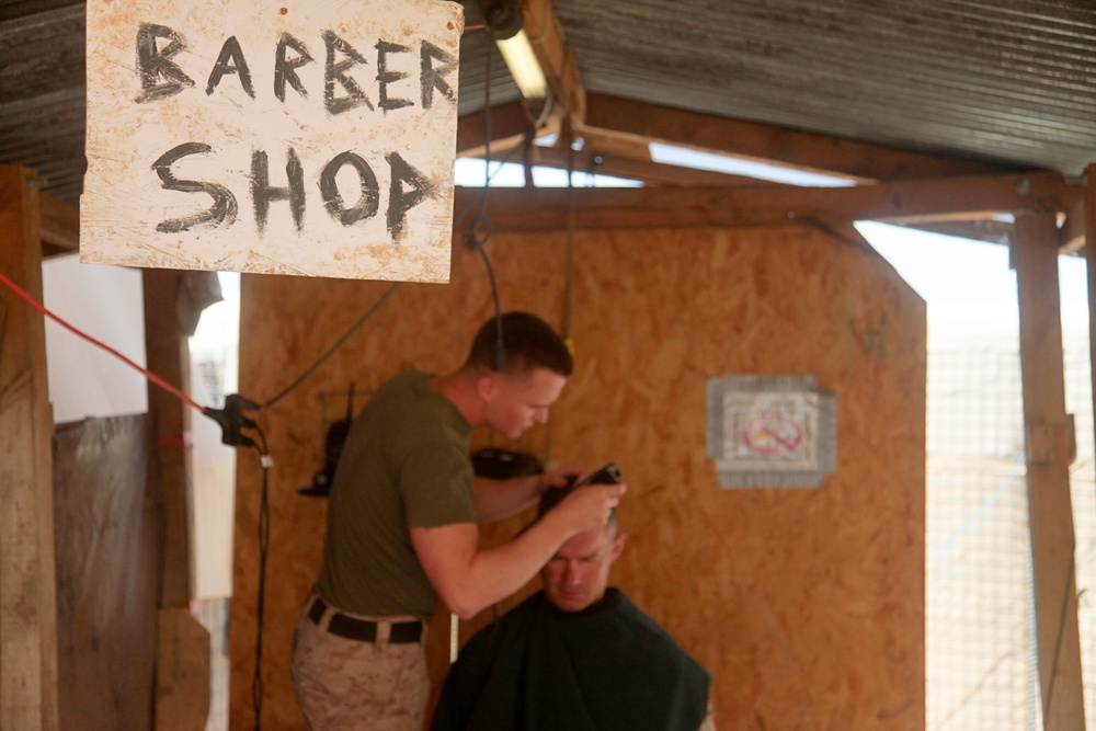 Marine cuts another's hair