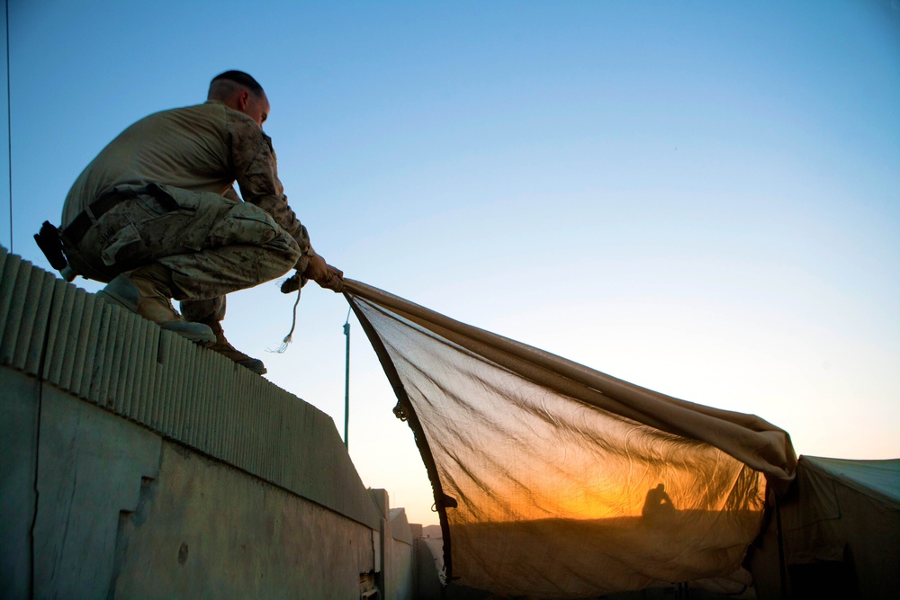 Marine pulls shade above gym