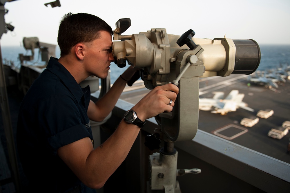 USS John C. Stennis sailor stands lookout