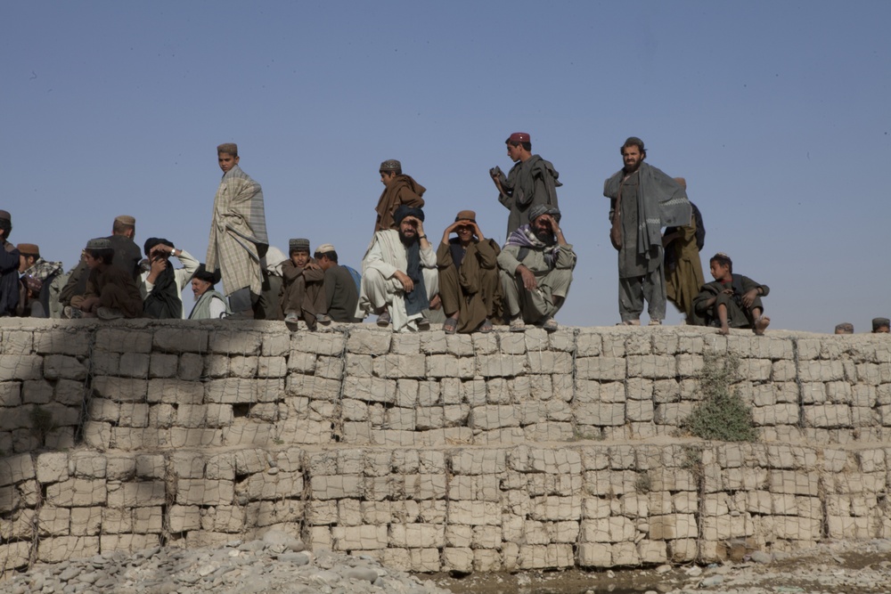 Afghans observe the construction of the Musa Qal'eh Wadi Crossing