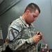 Communications soldier fixes phone cable