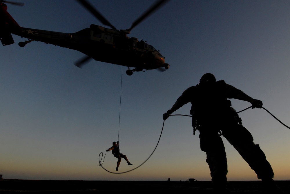 EODMU 2 sailor rappels from MH-60S Sea Hawk