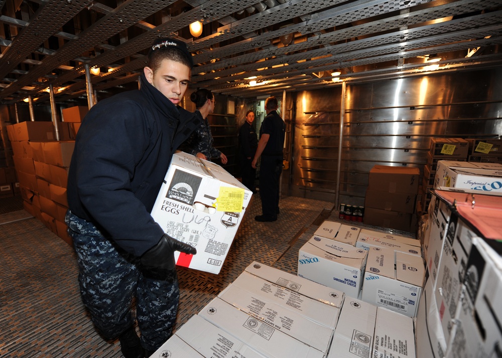 USS Wasp sailors stack boxes