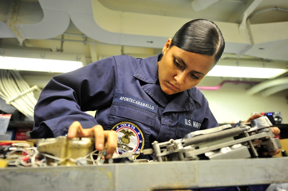 USS John C. Stennis sailor assembles bomb racks