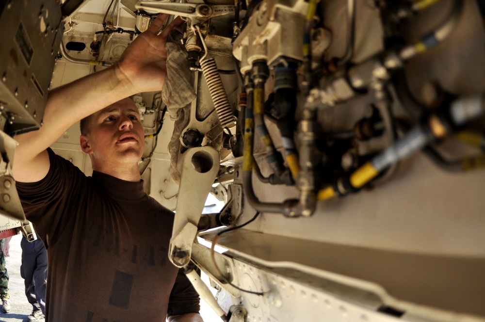 Airman cleans F/A-18E Super Hornet landing gear