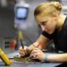 USS George H.W. Bush sailors work on electronics