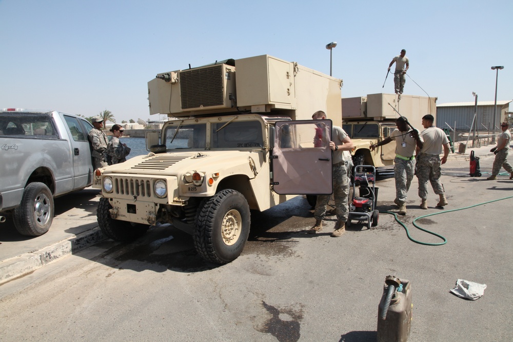 Troops clean vehicles on Victory Base Complex