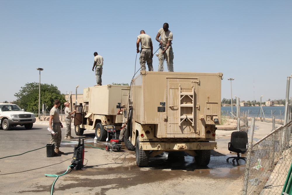 Troops clean vehicles on Victory Base Complex