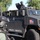 Operation Pipeline Express drug arrests The image shows a heavily armored tactical vehicle belonging to the Department of Homeland Security's Immigration and Customs Enforcement (ICE), specifically the SAC/LA field office. The vehicle is marked 'POLICE / RESCUE' and bears the DHS seal and an American flag decal. A tactical officer in full gear is positioned in the turret on top of the vehicle, while another officer in tactical gear is visible in the foreground.