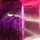 Operation Pipeline Express drug arrests A nighttime scene showing multiple individuals in tactical gear, helmets, and body armor positioned near a structure decorated with artificial spider webs and illuminated by pink/red and white lights. The setting appears to involve a Halloween-themed decoration or haunted house display, with fog effects visible on the ground. The personnel are clustered together near the entrance of the decorated structure.