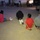Operation Pipeline Express drug arrests Four individuals are seated on the ground with their hands restrained behind their backs in what appears to be a law enforcement detention scenario at night. A vehicle marked 'SWAT' is visible on the right side of the image. The scene takes place in an outdoor dirt/gravel area near several structures.