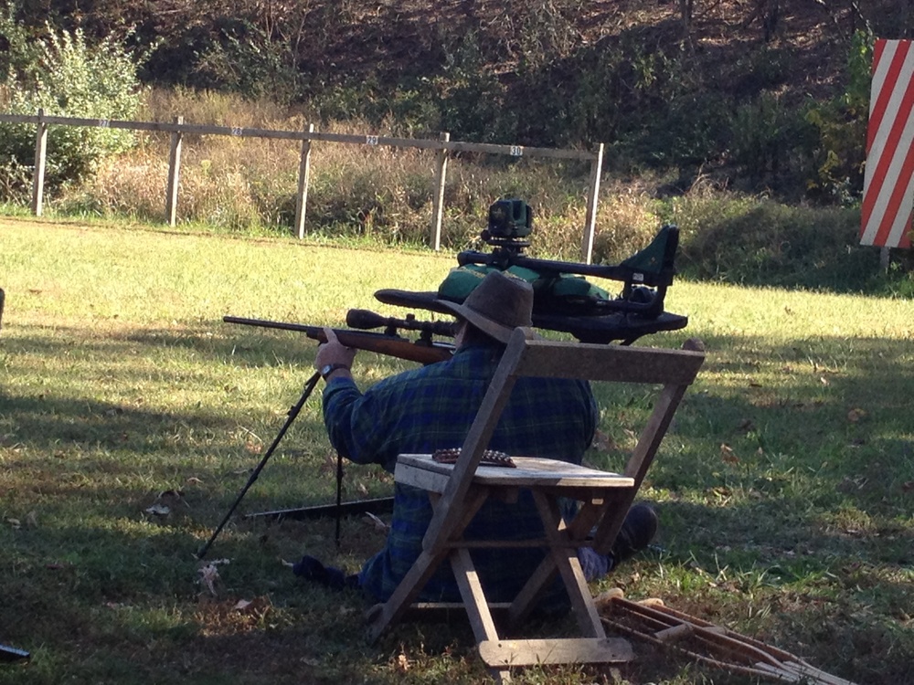 Hunter with a disability sights his rifle during target practice