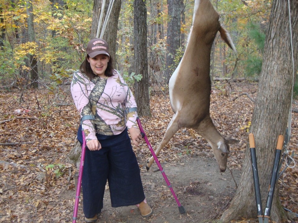 Young hunter with disability poses with her doe