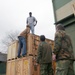 Marines and Norwegian military members assemble Air Force pallets of supplies for earthquake victims in Eastern Turkey