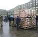 Marines and Norwegien military members asseble Air Force pallets of supplies for earthquake victims in Eastern Turkey