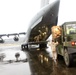 Marines and airmen load a C-17 with pallets of supplies for earthquake victims in eastern Turkey