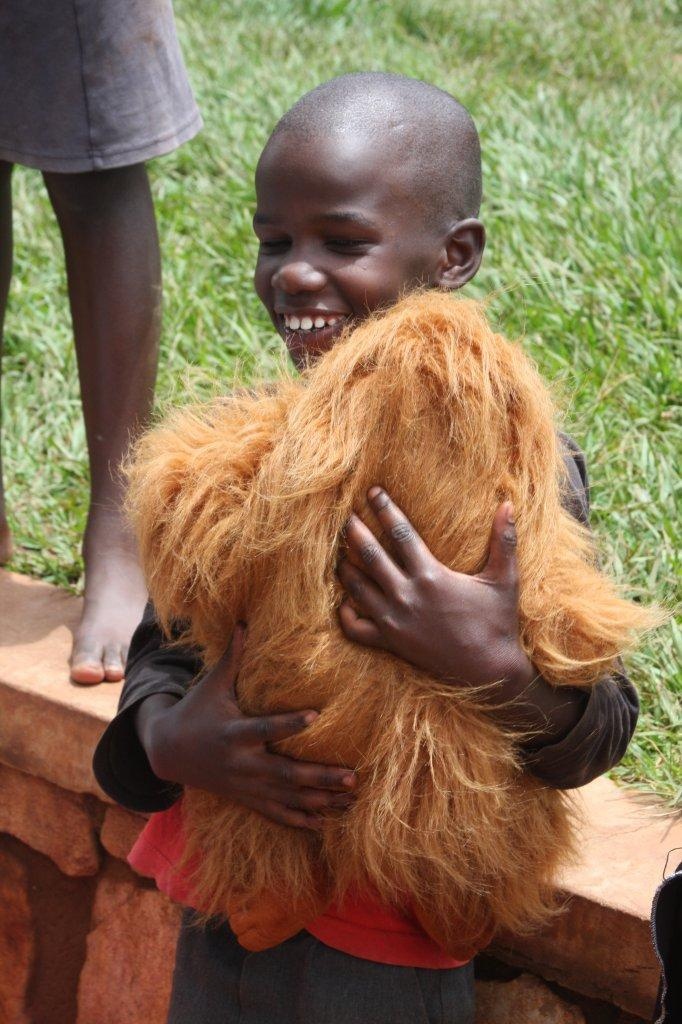 Service members deliver teddy bears to Ugandan children