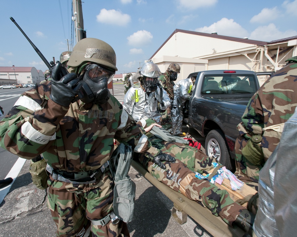 Yokota airmen perform a simulated casualty care in a contaminated environment