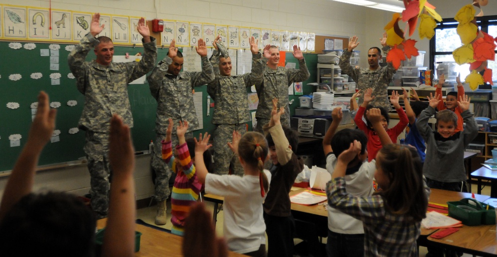 Students cheer with soldiers