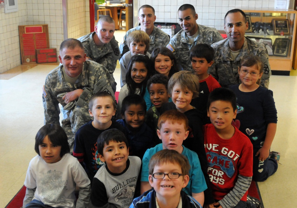 Soldiers pose with second graders