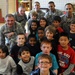 Soldiers pose with second graders