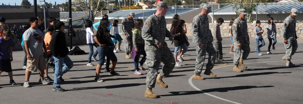 Soldiers dance with students
