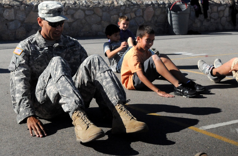 Soldiers do situps with students