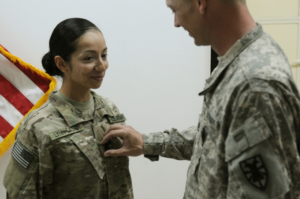 Newly promoted sergeant first class pins rank at Camp Buehring